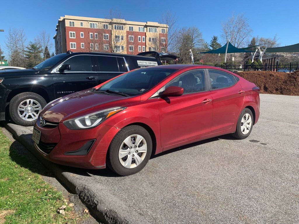 Hand drying a car after exterior detailing in Cheshire, Connecticut