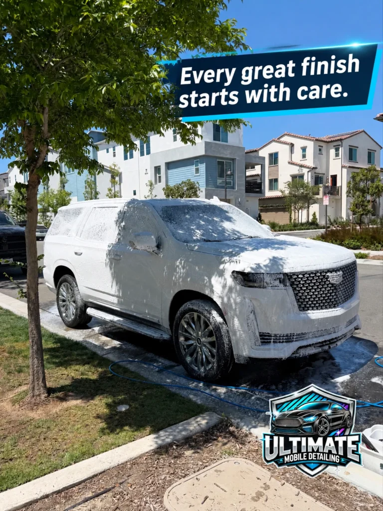 White Cadillac Escalade covered in wash foam beneath Every great finish starts with care banner