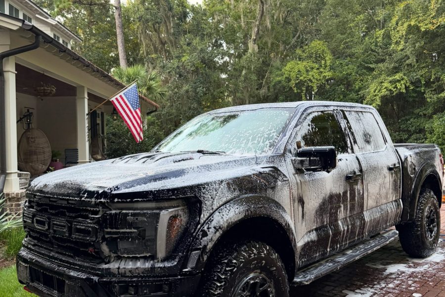 Exterior hand wash removing dirt from a vehicle’s paint and wheels in Cypress, Texas
