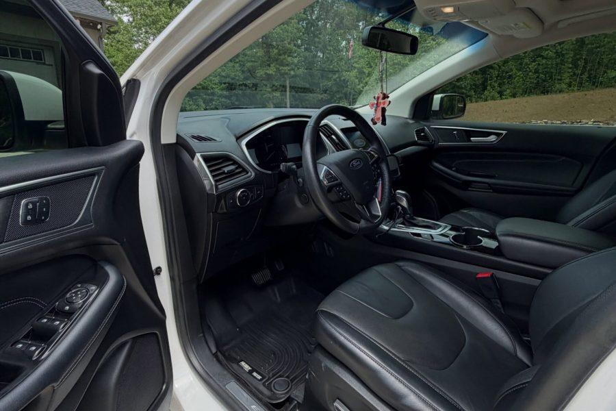 Vehicle cabin undergoing careful vacuuming with dashboard and upholstery care in Sebastian, Florida